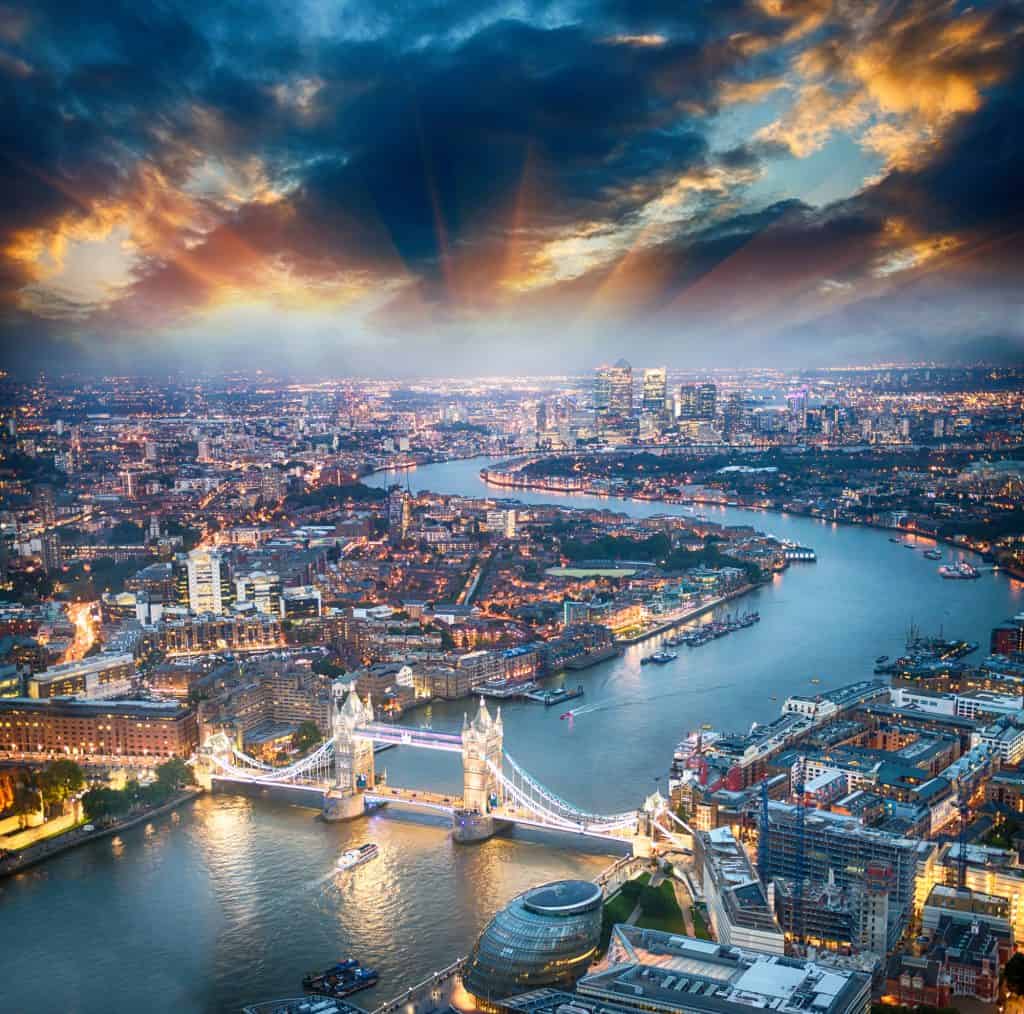 London. Aerial view of Tower Bridge at dusk with beautiful city skyline.